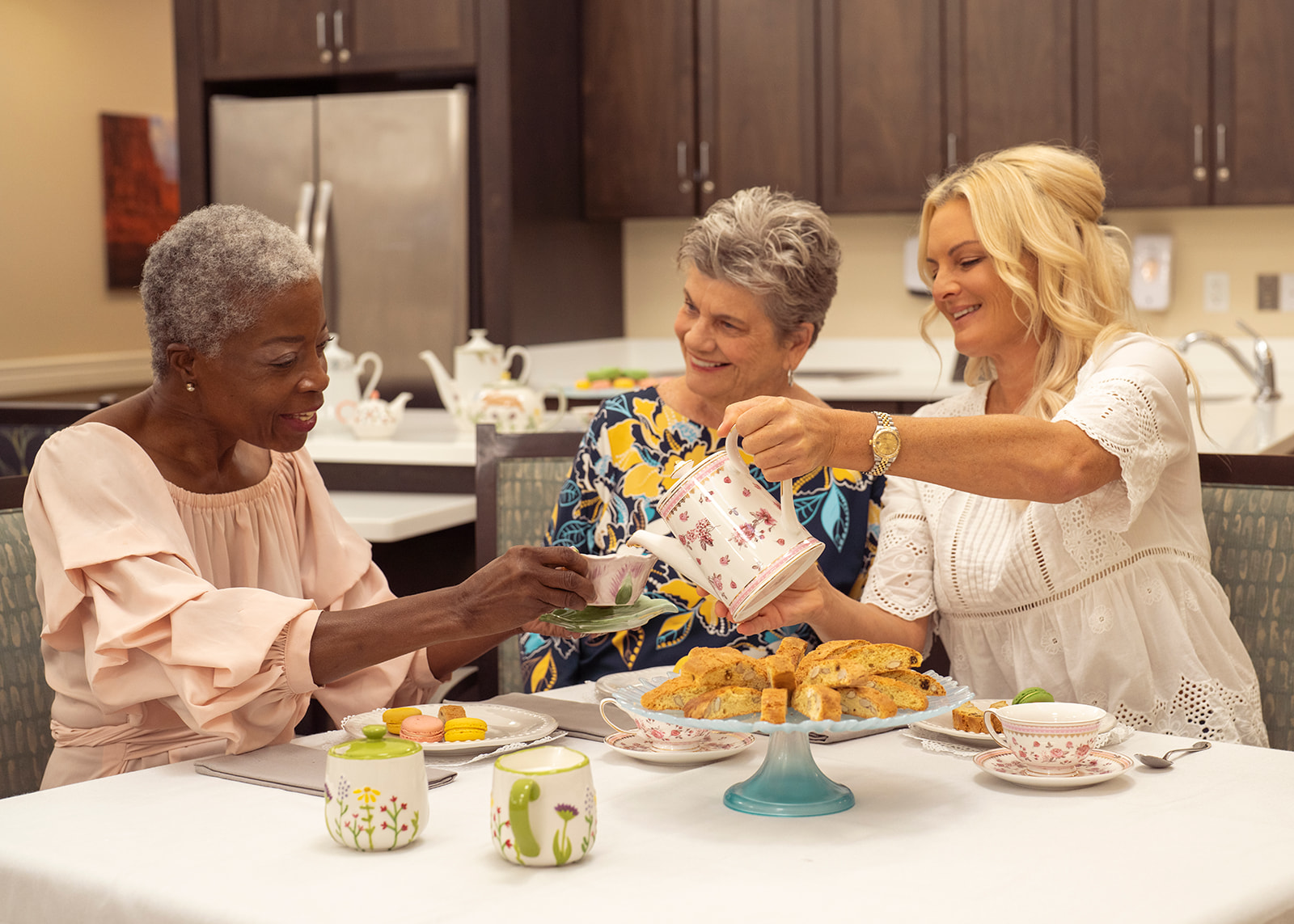 Three women enjoying tea and pastries together