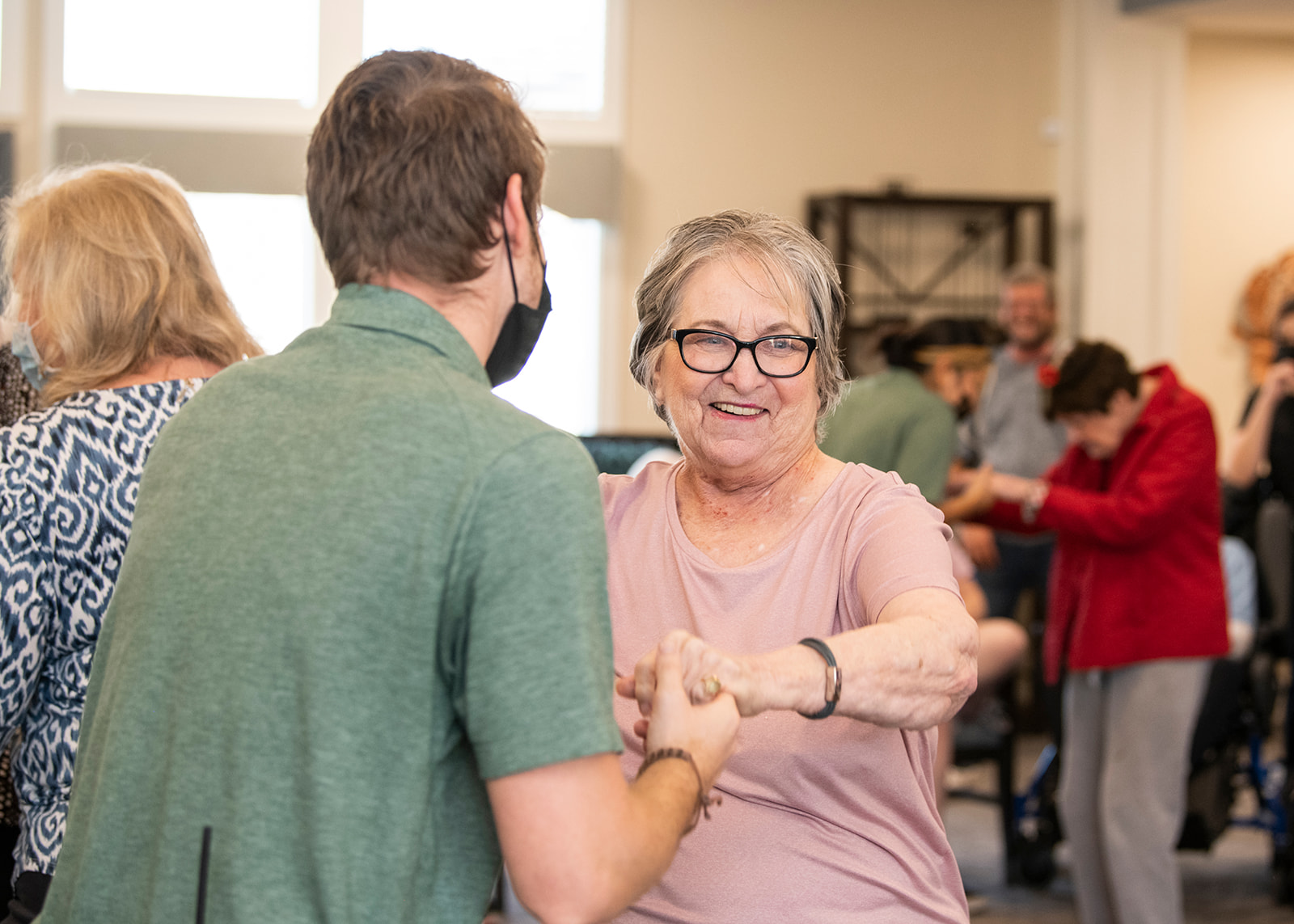 Older woman dancing with partner indoors