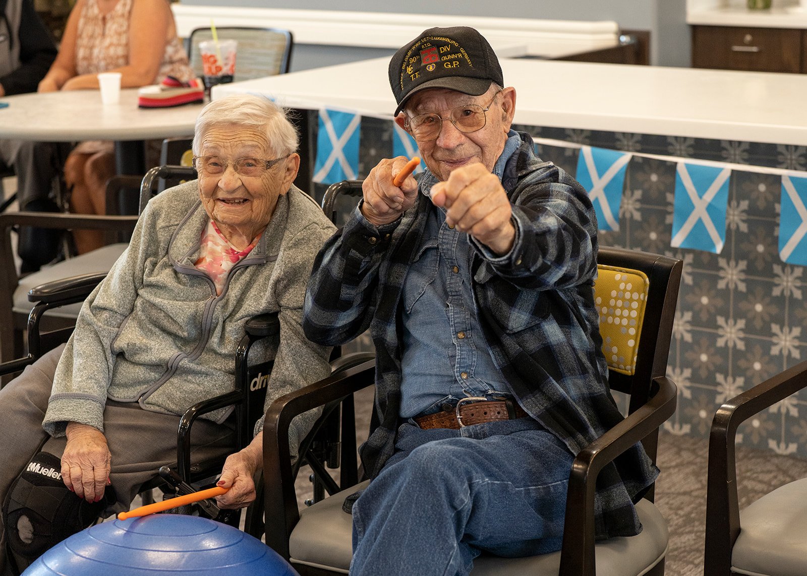 Elderly couple playing percussion at senior center