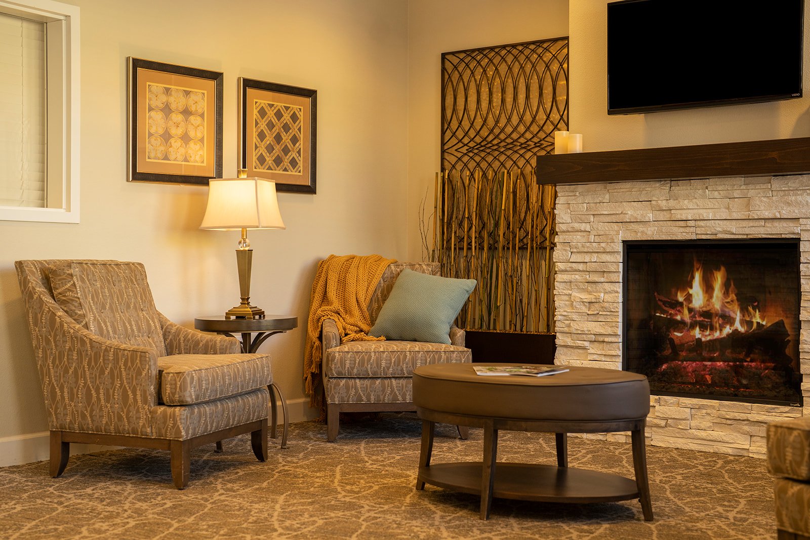 Cozy living room with stone fireplace and armchairs