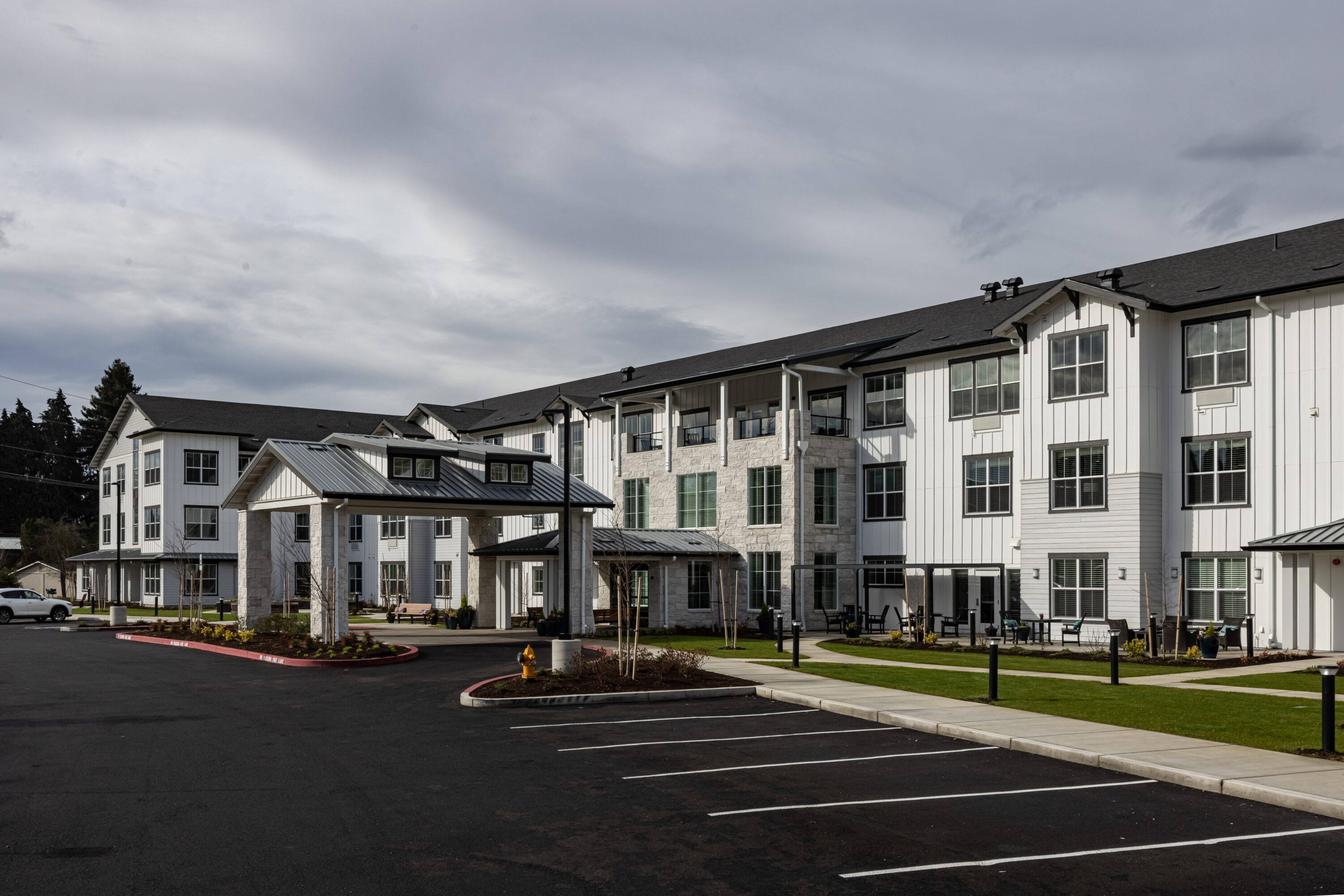 Modern three-story apartment building with covered entrance