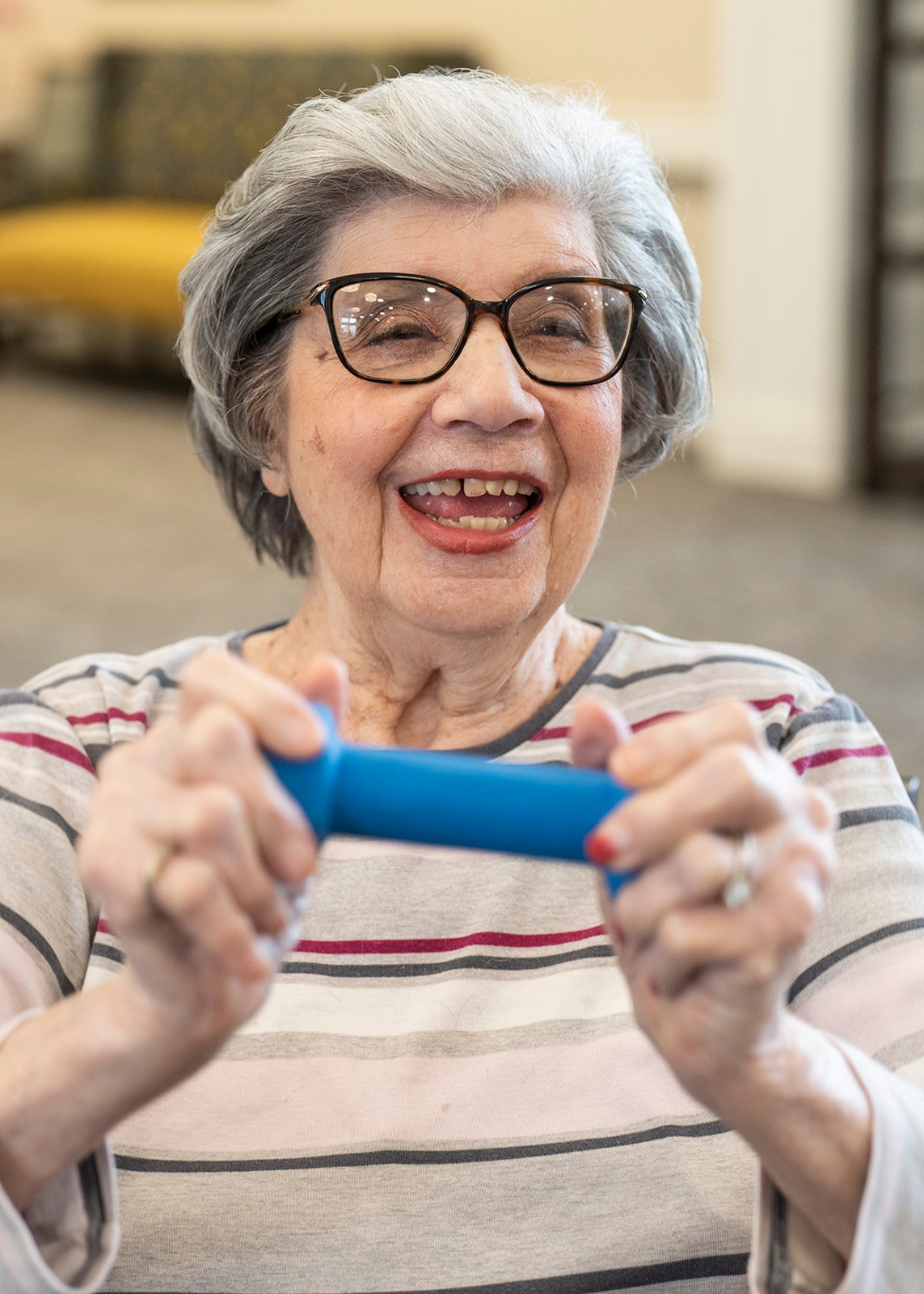 Smiling senior woman exercising with resistance band